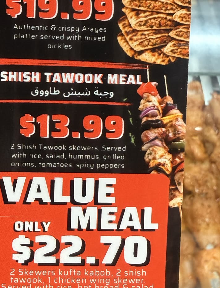 Shish tawook skewers with char marks, off the coals